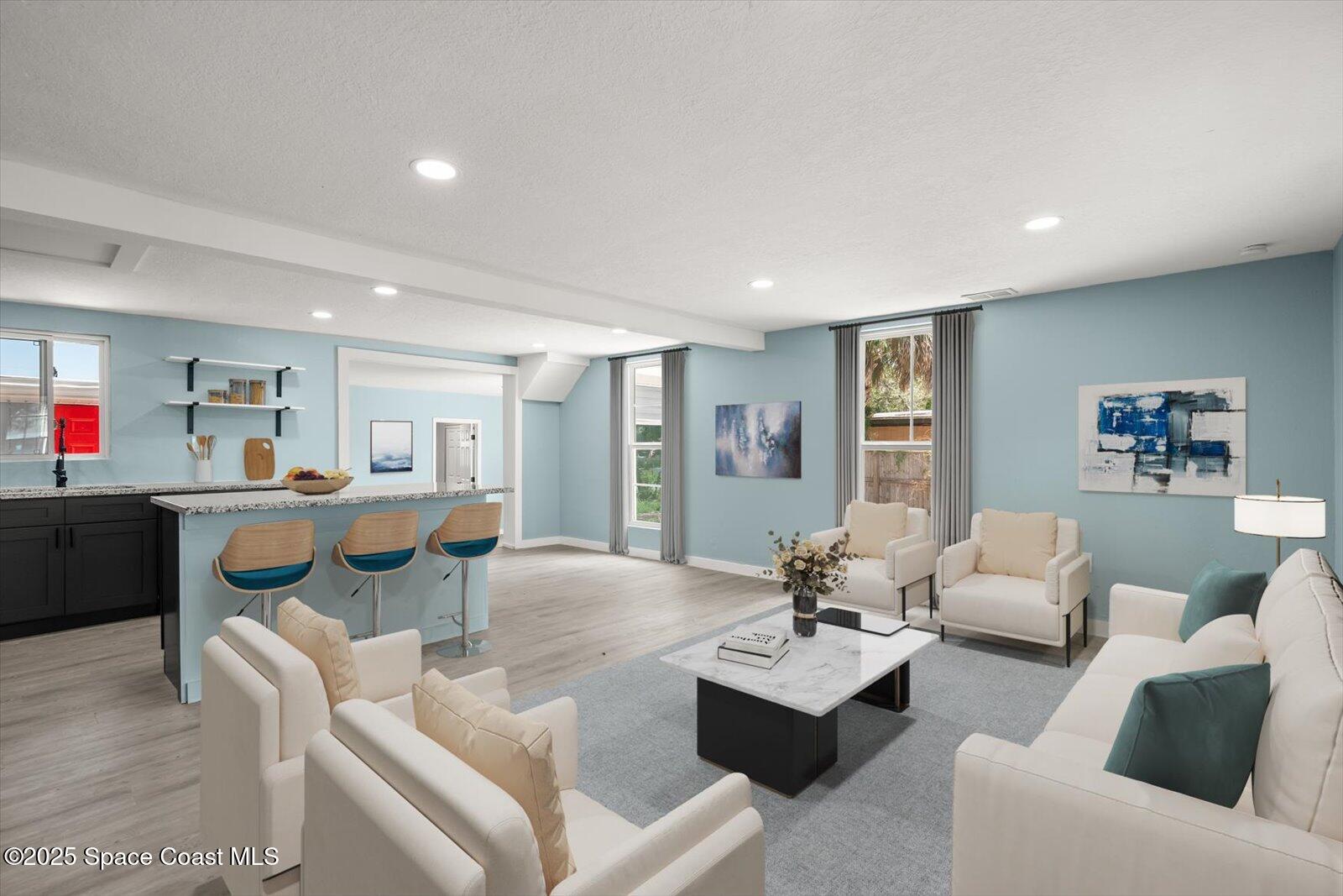 1436 Melrose Street Cocoa, FL 32922 - Photo 2 of 28 a living room with furniture kitchen view and a dining table