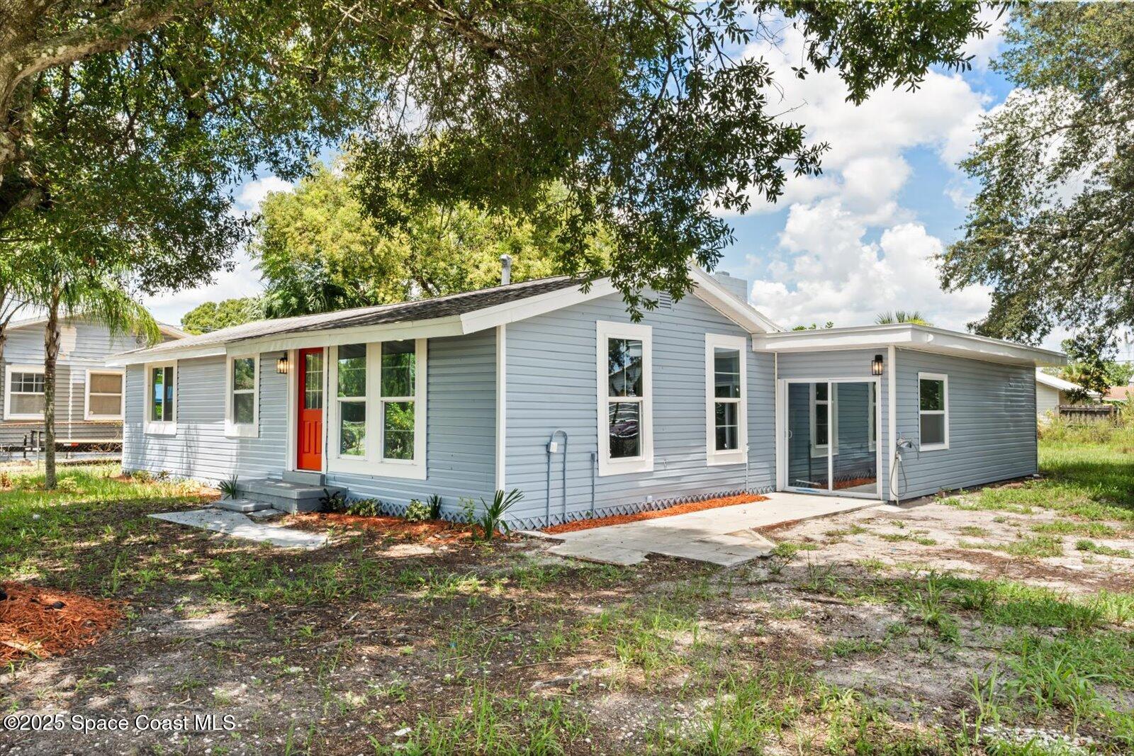 1436 Melrose Street Cocoa, FL 32922 - Photo 24 of 28 a front view of a house with a yard and trees