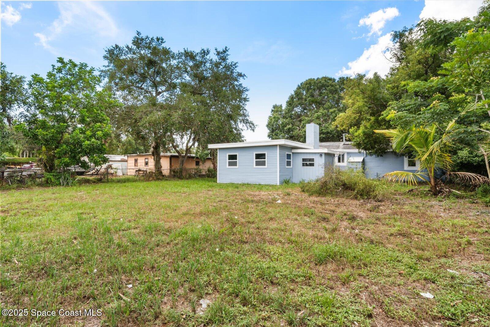 1436 Melrose Street Cocoa, FL 32922 - Photo 25 of 28 a view of a white house that has a tree in front of it