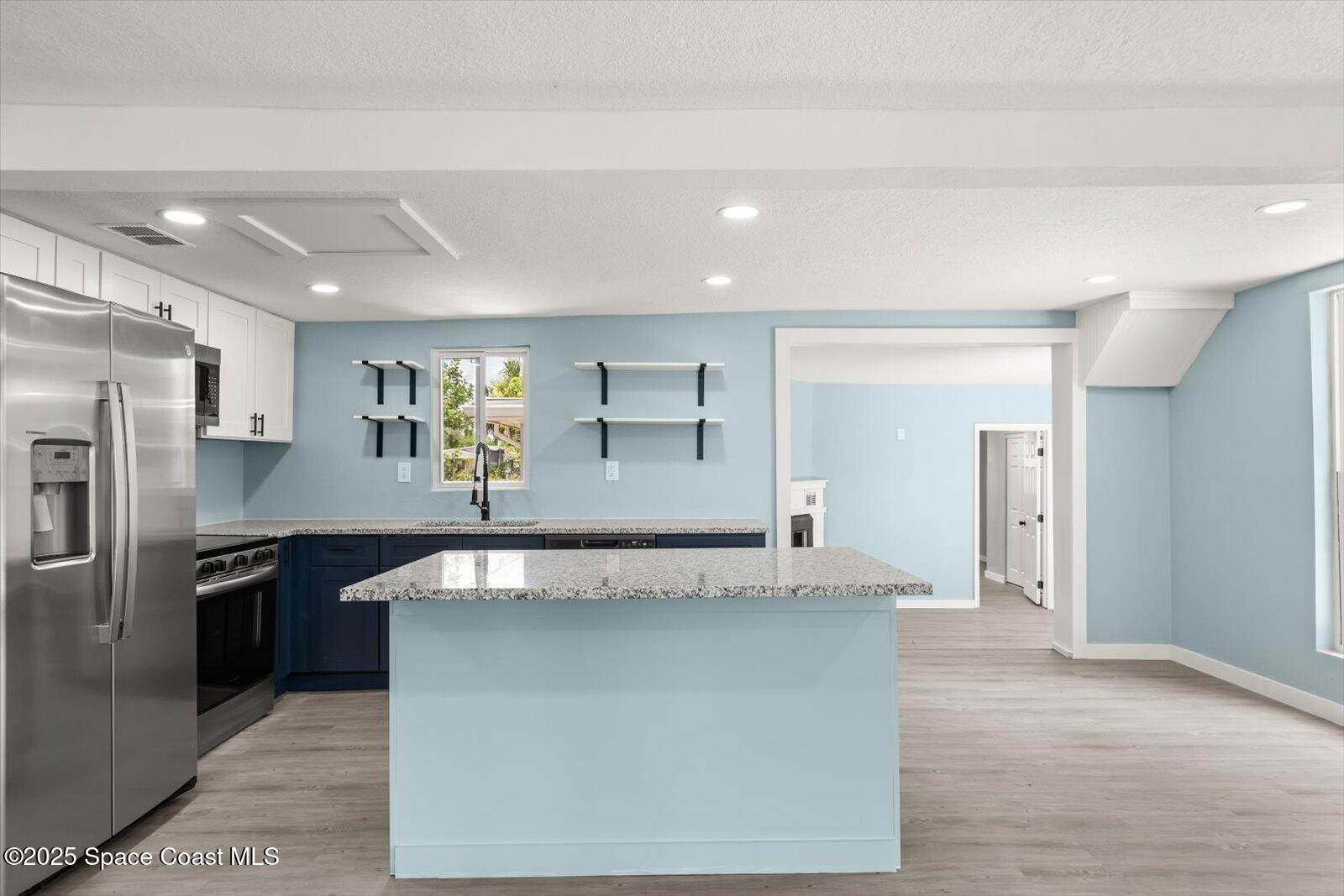 1436 Melrose Street Cocoa, FL 32922 - Photo 6 of 28 a view of a kitchen with granite countertop a refrigerator and a sink