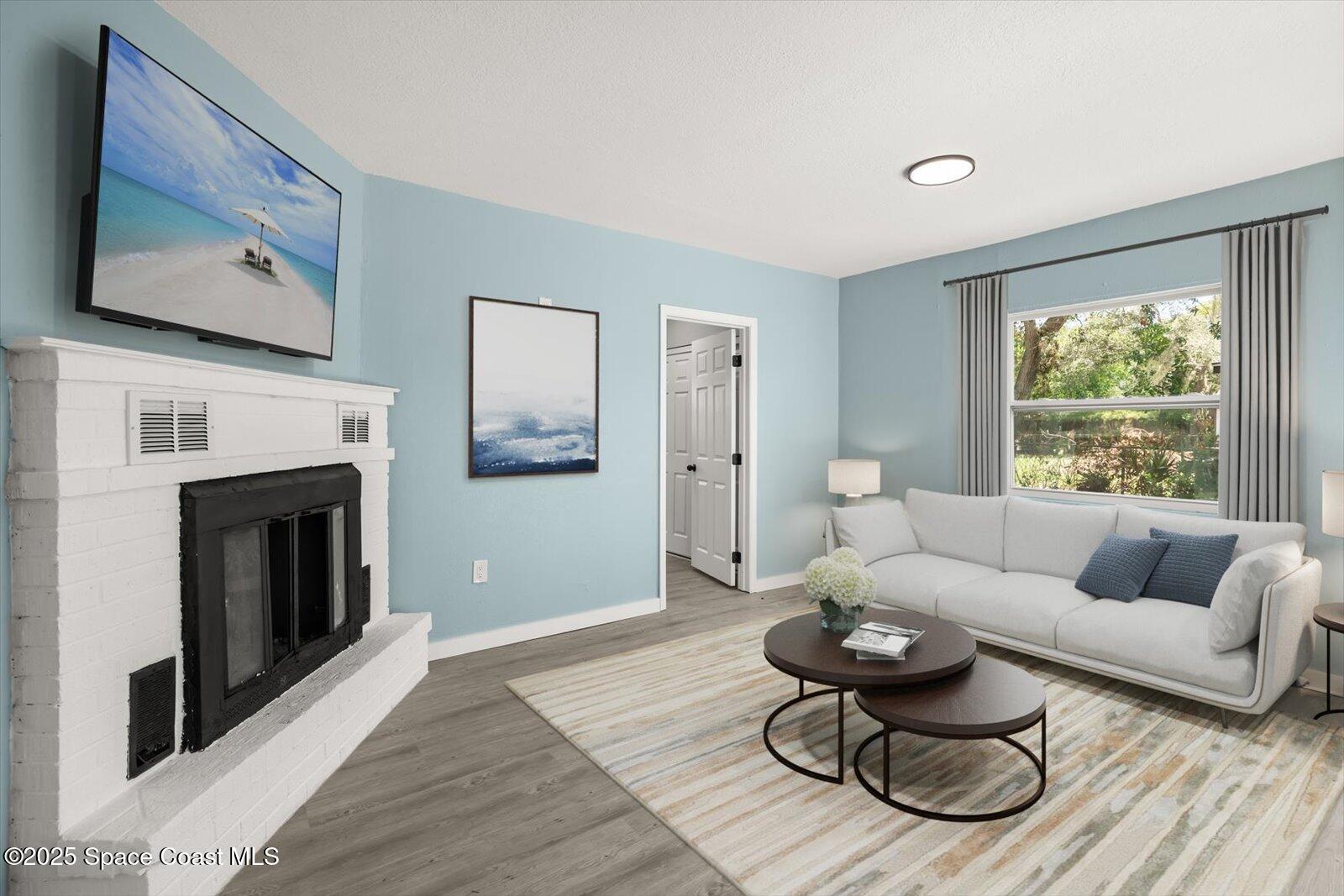 1436 Melrose Street Cocoa, FL 32922 - Photo 10 of 28 a living room with furniture and a fireplace