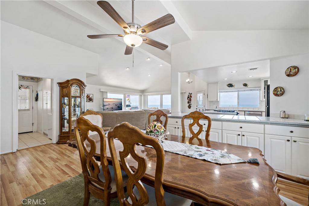 6536 Oceanview Drive, Unit T Carlsbad, CA 92011 - Photo 23 of 44 a kitchen with stainless steel appliances granite countertop a dining table chairs refrigerator and cabinets