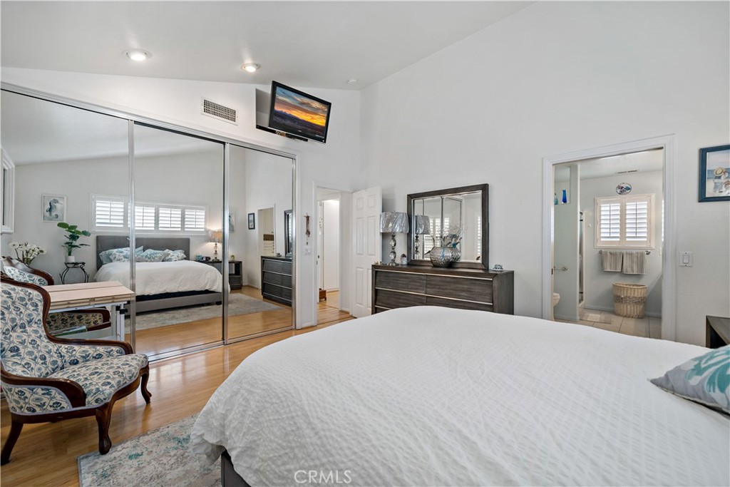 6536 Oceanview Drive, Unit T Carlsbad, CA 92011 - Photo 25 of 44 a bedroom with a large bed and a chandelier