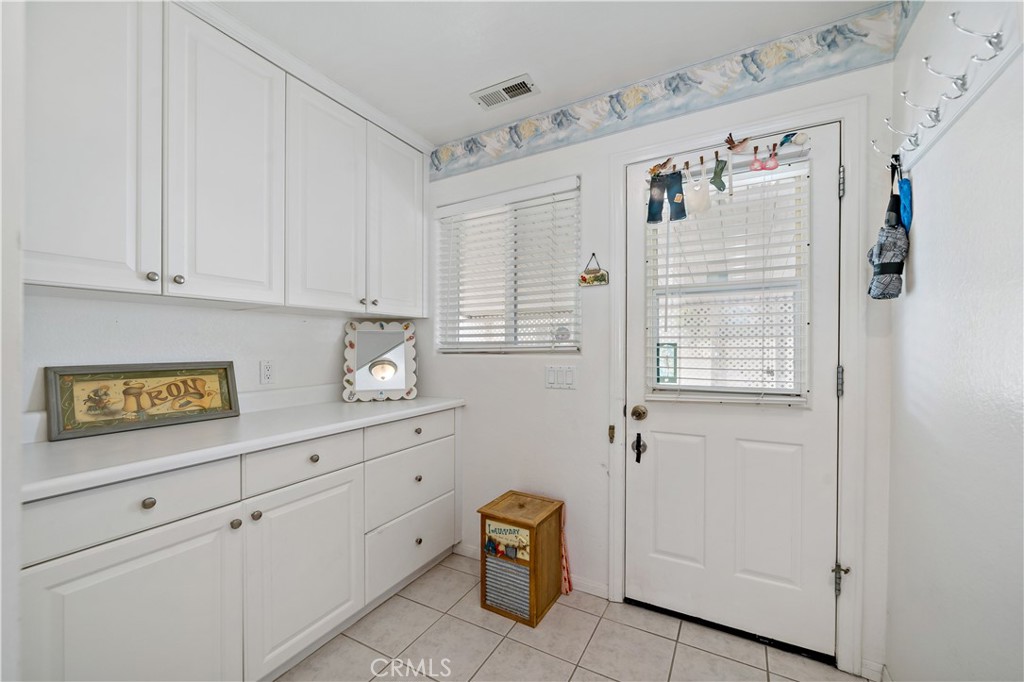 6536 Oceanview Drive, Unit T Carlsbad, CA 92011 - Photo 32 of 44 a view of kitchen with cabinets and wooden floor
