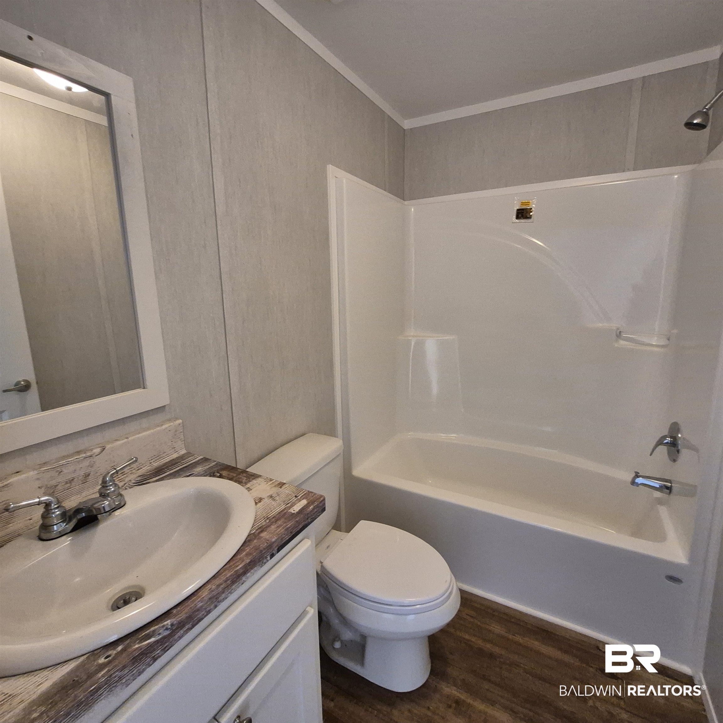 8867 Old Stage Road Repton, AL 36475 - Photo 26 of 37 Full bathroom with vanity, tub / shower combination, and dark wood-style flooring