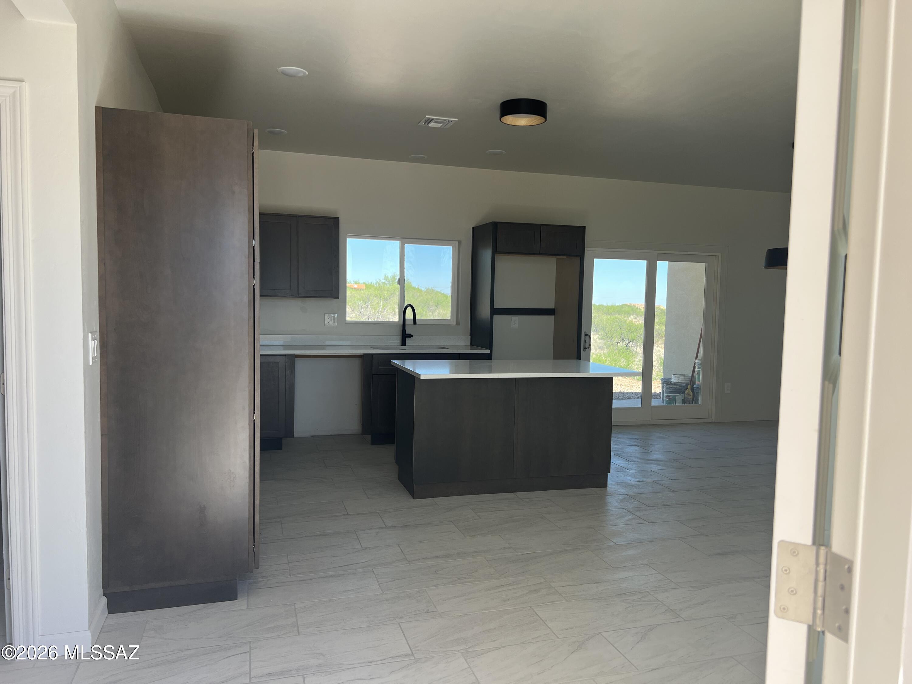 1501 Circulo Sombrero Rio Rico, AZ 85648 - Photo 7 of 26 a kitchen with kitchen island sink and window