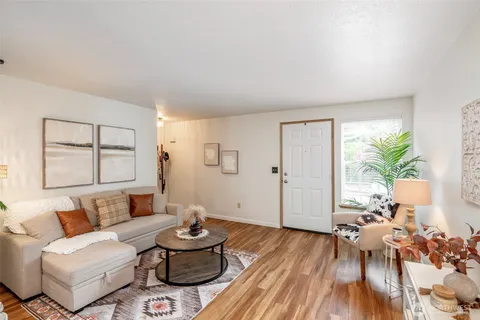 a living room with furniture and wooden floor