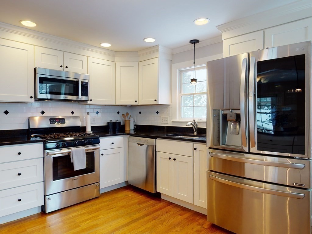 29 Baker Road Arlington, MA 02474 - Photo 14 of 36 a kitchen with stainless steel appliances a refrigerator stove and microwave