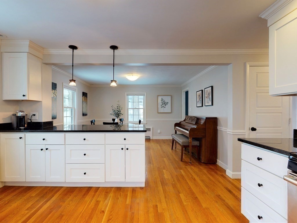 29 Baker Road Arlington, MA 02474 - Photo 17 of 36 a kitchen with granite countertop white cabinets and white appliances