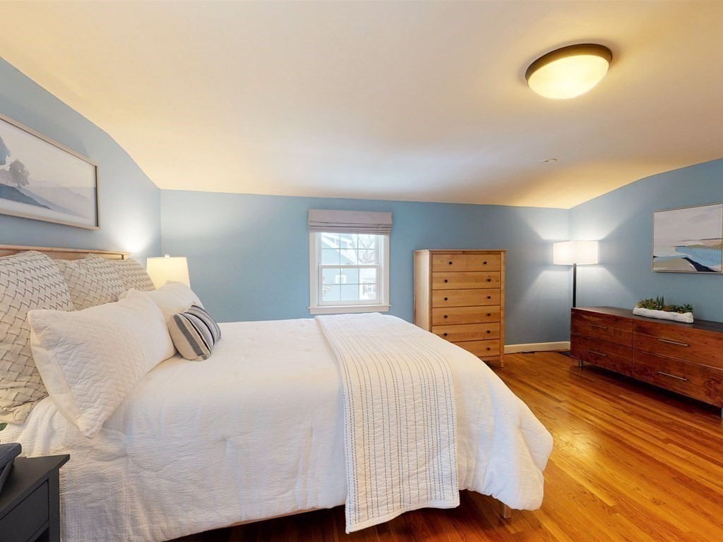 29 Baker Road Arlington, MA 02474 - Photo 21 of 36 a bedroom with a bed and wooden floor