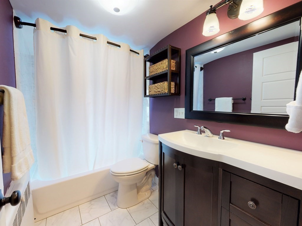 29 Baker Road Arlington, MA 02474 - Photo 23 of 36 a bathroom with a sink a toilet and a mirror