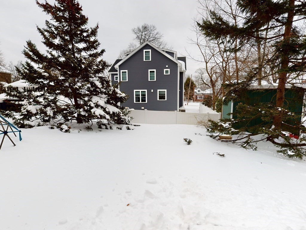 29 Baker Road Arlington, MA 02474 - Photo 32 of 36 a view of a house with a snow in the yard