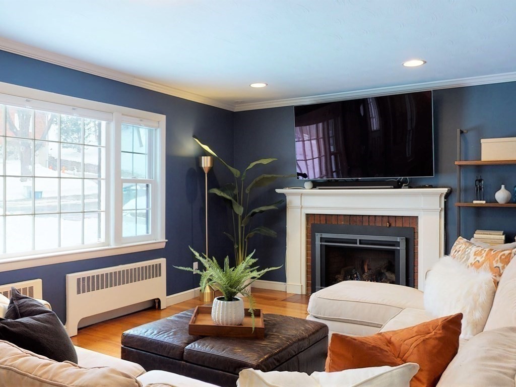 29 Baker Road Arlington, MA 02474 - Photo 4 of 36 a living room with furniture a fireplace and a flat screen tv