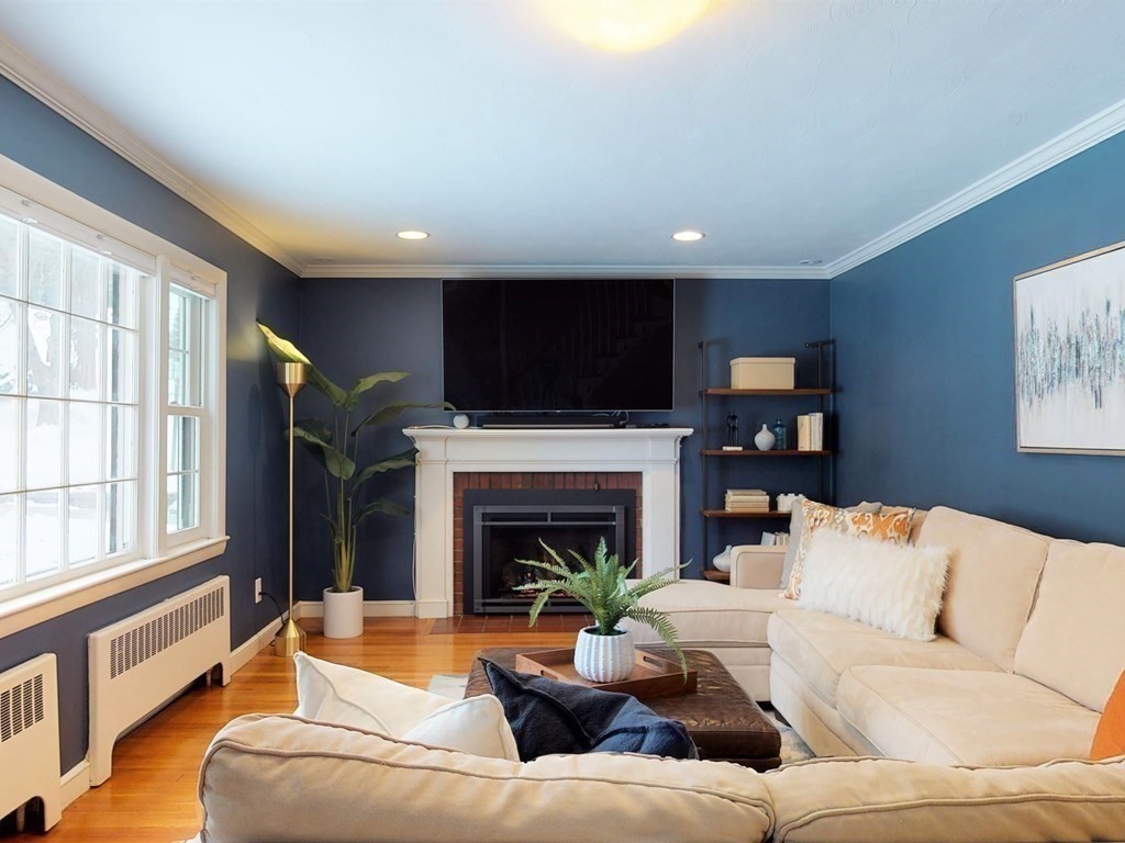 29 Baker Road Arlington, MA 02474 - Photo 5 of 36 a living room with furniture a fireplace and a flat screen tv