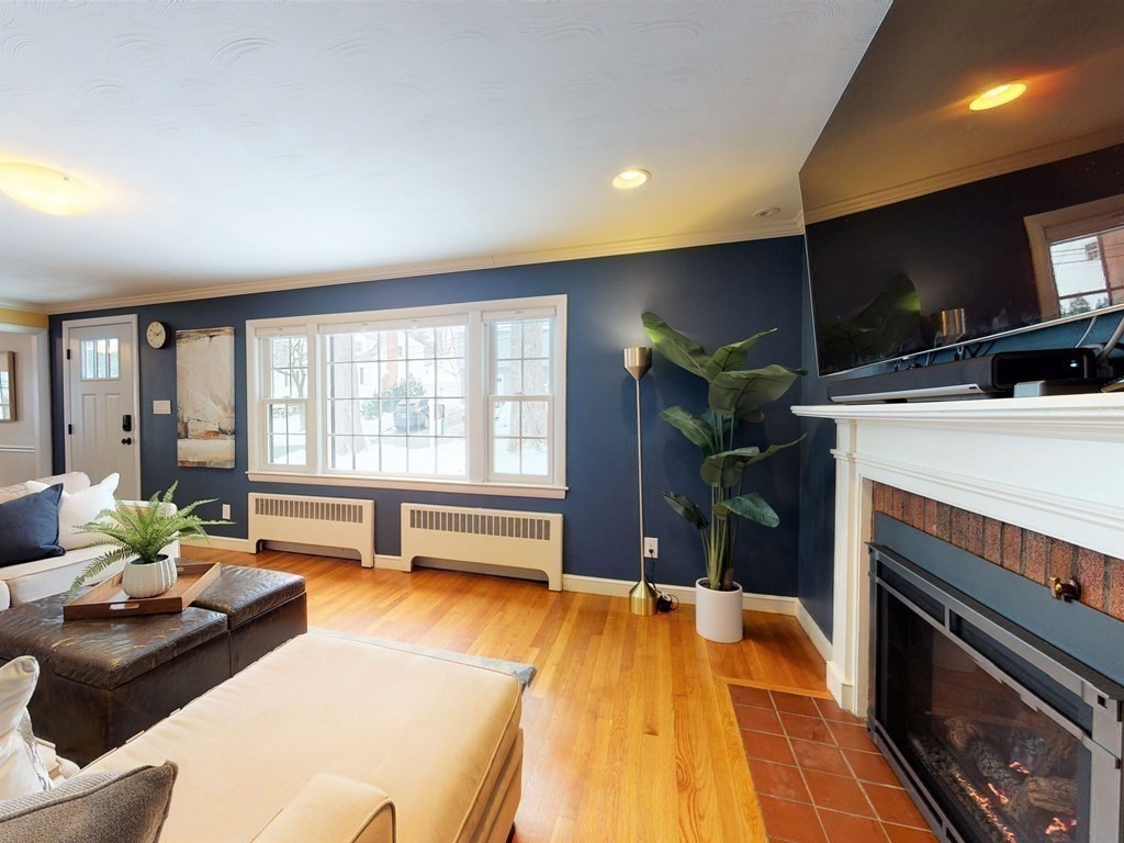 29 Baker Road Arlington, MA 02474 - Photo 7 of 36 a living room with a fireplace furniture and a flat screen tv