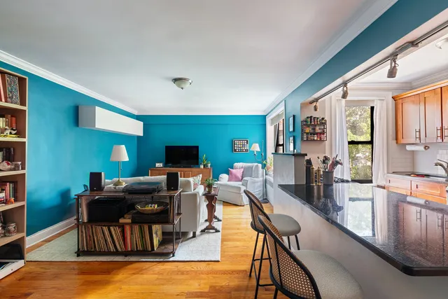 a living room with furniture a flat screen tv and a large window