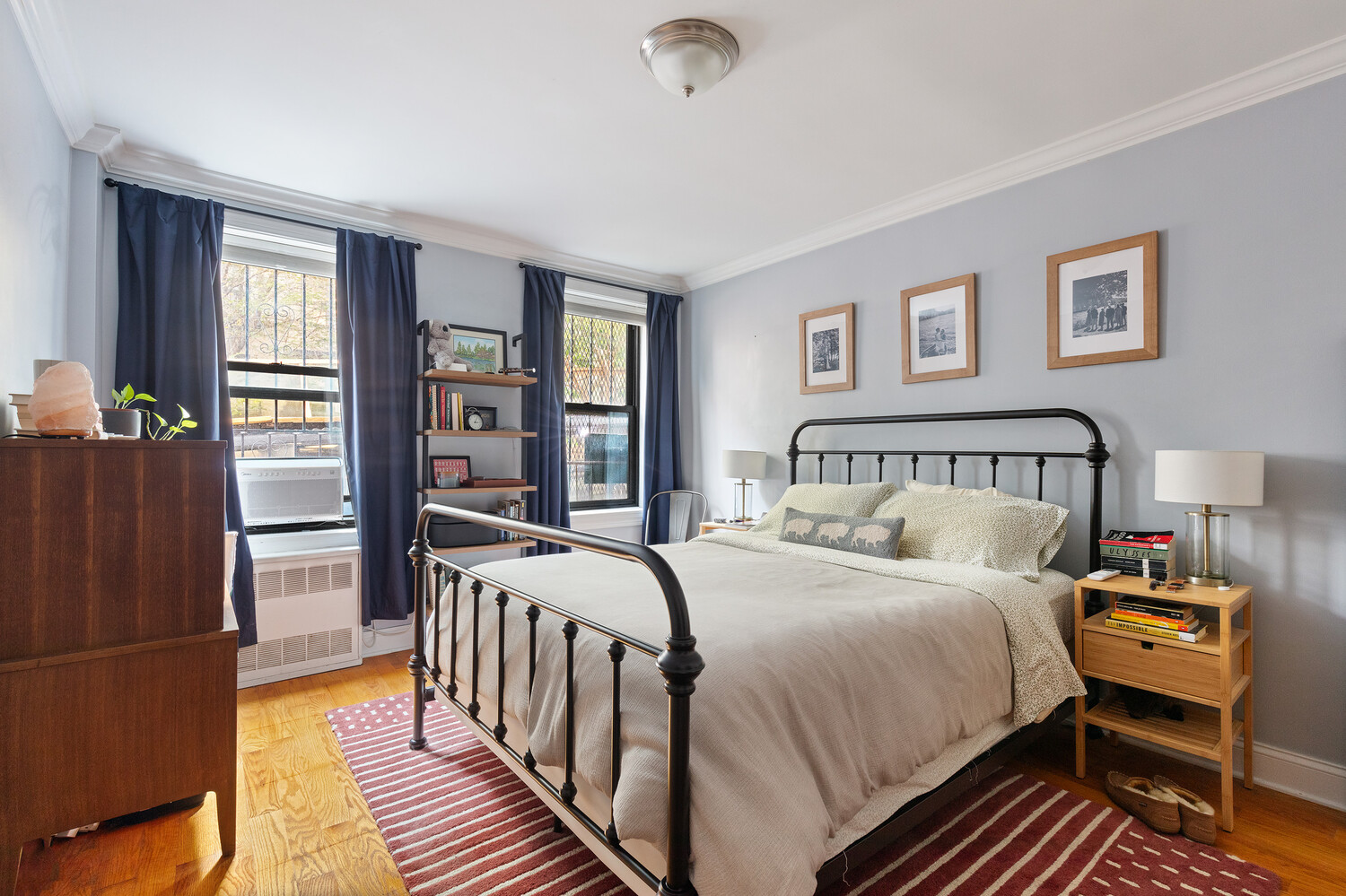 245 Bennett Avenue, Unit 3B Manhattan, NY 10040 - Photo 4 of 7 a bedroom with a bed next to a large window