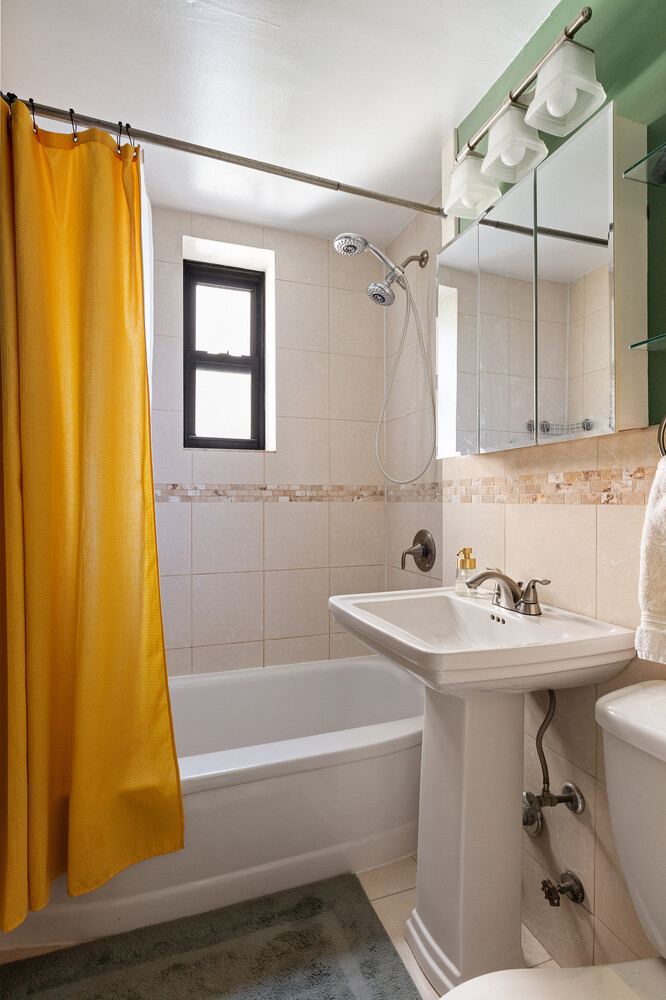 245 Bennett Avenue, Unit 3B Manhattan, NY 10040 - Photo 6 of 7 a bathroom with a sink a toilet and shower