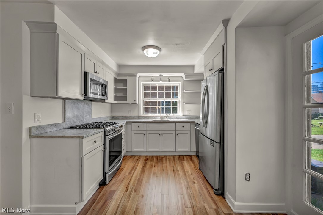 3543 Lytle Road Shaker Heights, OH 44122 - Photo 23 of 49 Kitchen featuring light cabinetry, stainless steel appliances, wood-finish flooring, stone-finish countertops, and a window above the sink