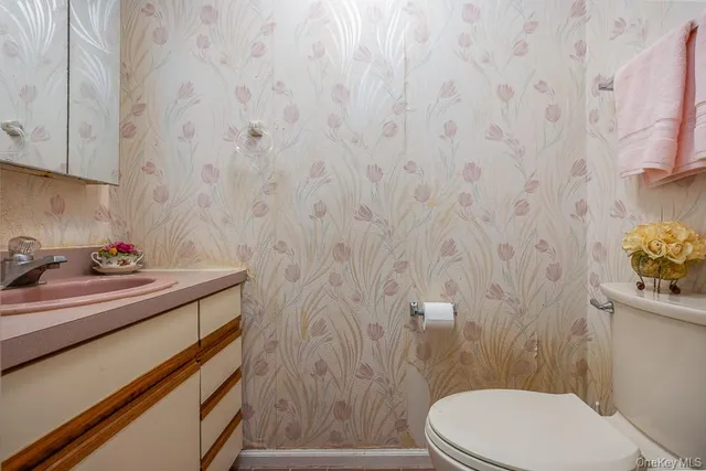 a bathroom with a sink a toilet and a shower curtain