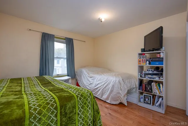 a bedroom with a bed and a book shelf