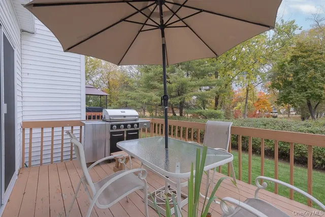 a view of balcony with furniture and umbrella