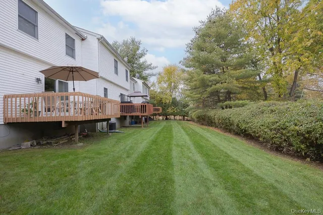 a view of a house with a swimming pool and sitting area
