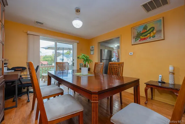 a view of a workspace with furniture and a potted plant