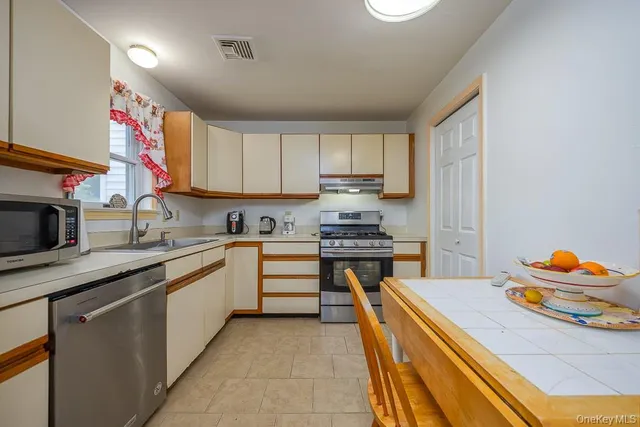 a kitchen with stainless steel appliances granite countertop a sink and cabinets