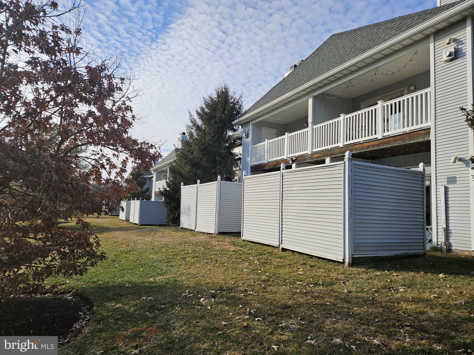 2702 Waters Edge Drive, Unit 2 Newark, DE 19702 - Photo 1 of 25 a view of a white house with a yard