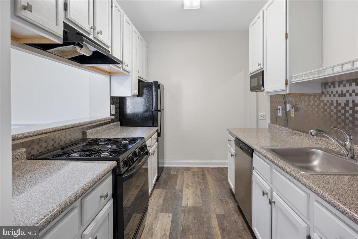 2702 Waters Edge Drive, Unit 2 Newark, DE 19702 - Photo 12 of 25 a kitchen with granite countertop a sink stove and cabinets