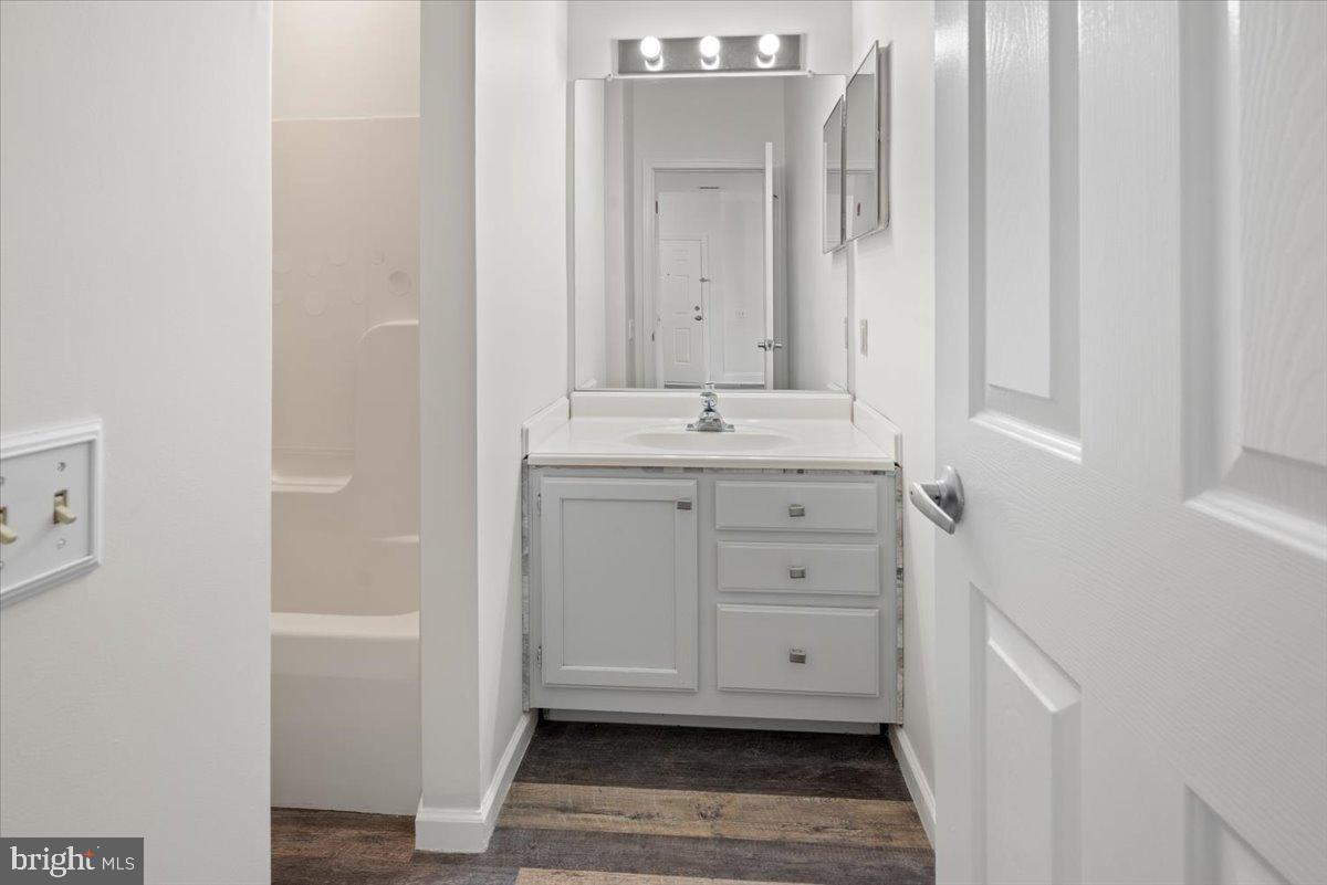 2702 Waters Edge Drive, Unit 2 Newark, DE 19702 - Photo 16 of 25 a bathroom with a granite countertop sink and a mirror