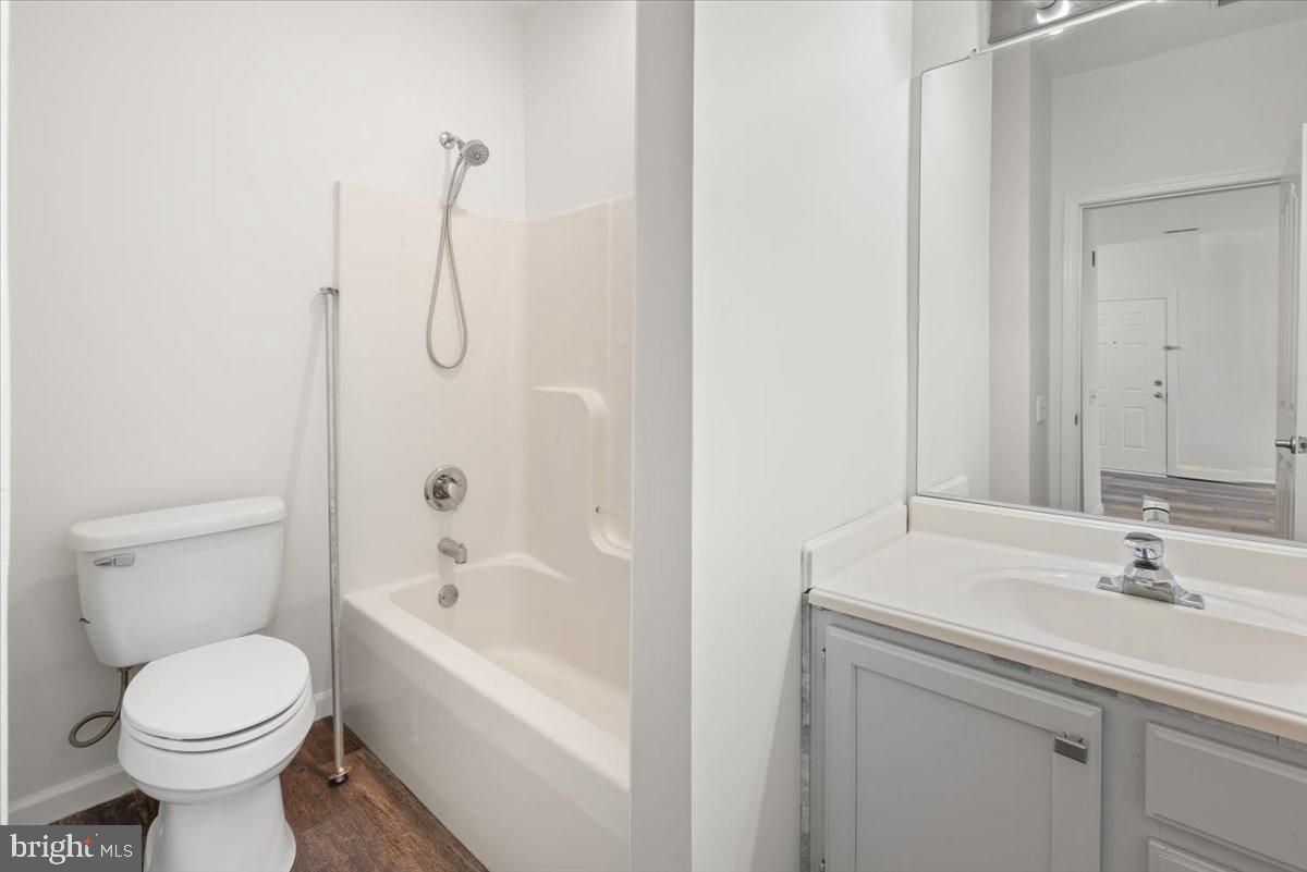 2702 Waters Edge Drive, Unit 2 Newark, DE 19702 - Photo 17 of 25 a bathroom with a sink a toilet and shower