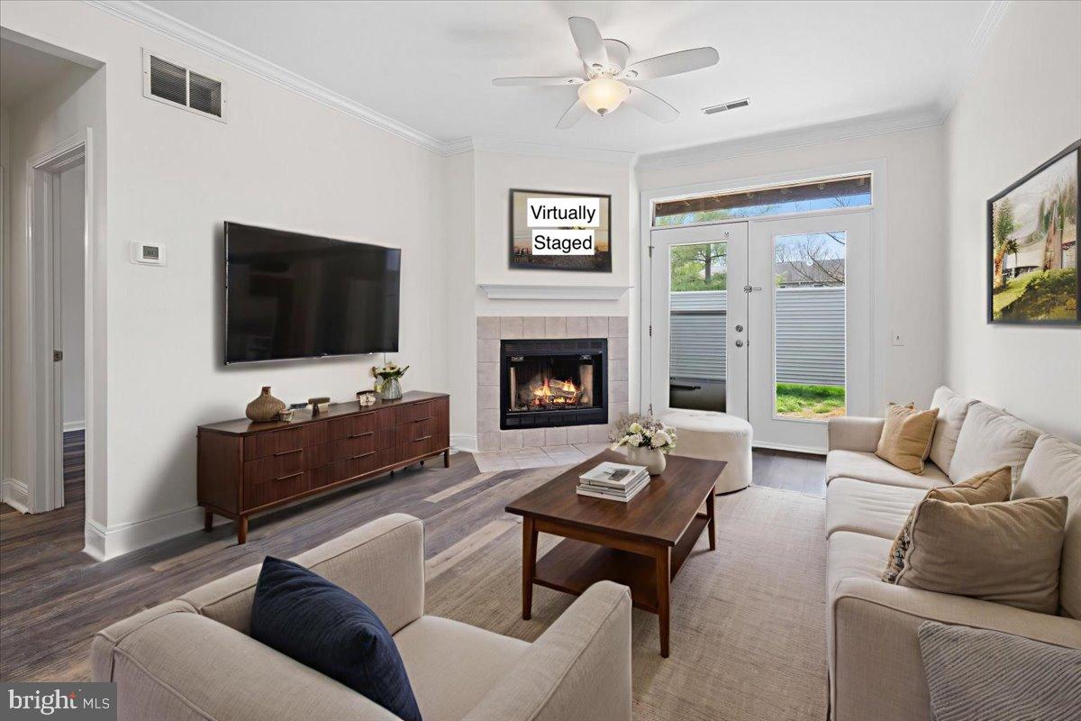 2702 Waters Edge Drive, Unit 2 Newark, DE 19702 - Photo 7 of 25 a living room with furniture flat screen tv and a fireplace