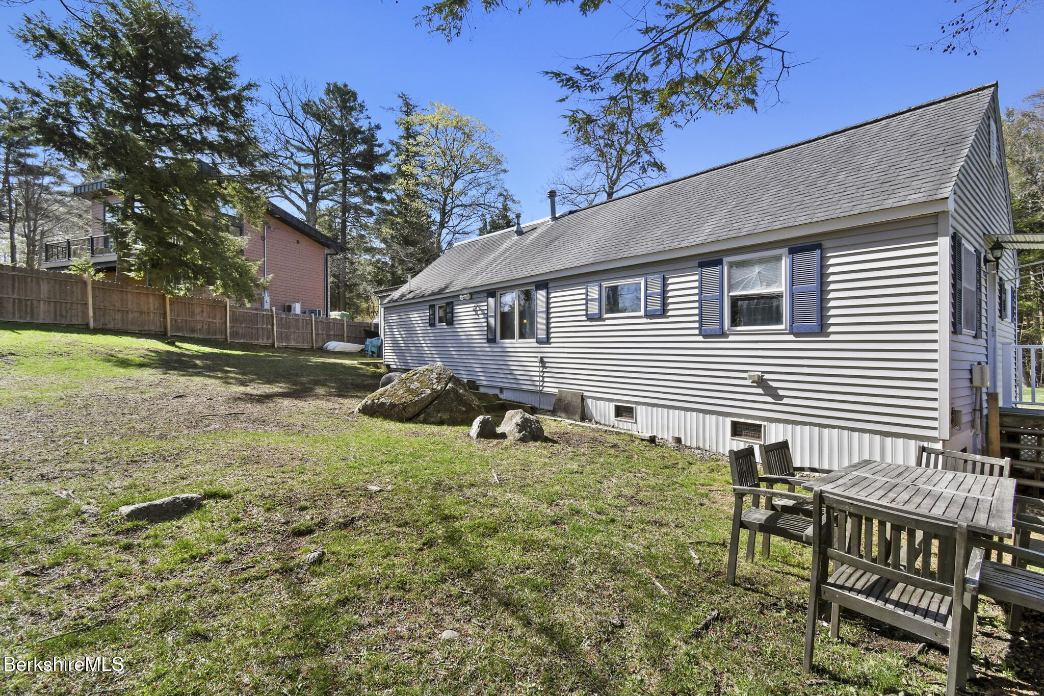 27 Shore Road Becket, MA 01223 - Photo 1 of 27 a view of a house with backyard and sitting area