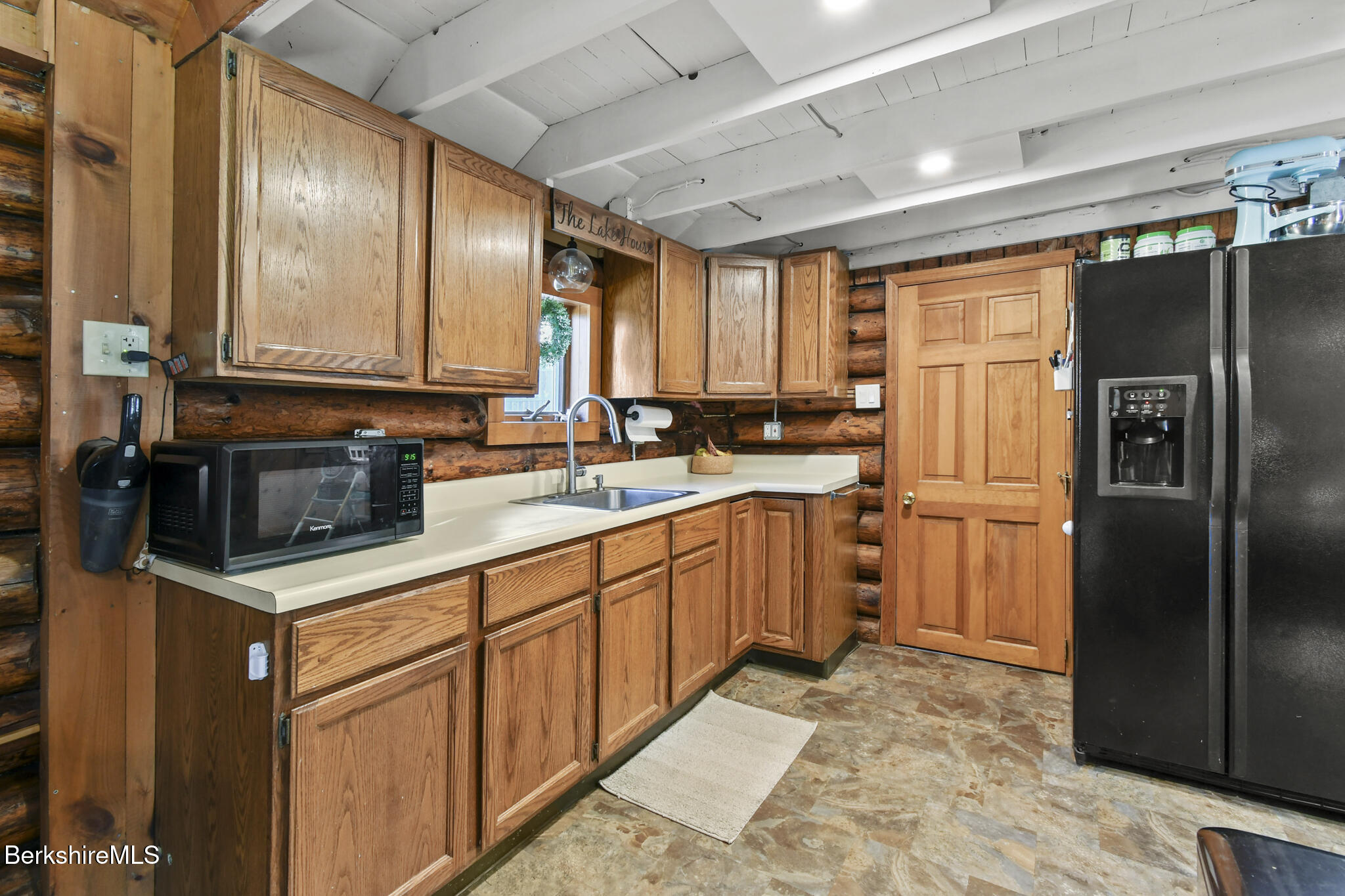 27 Shore Road Becket, MA 01223 - Photo 11 of 27 a kitchen with stainless steel appliances granite countertop a refrigerator a sink dishwasher a stove with wooden cabinets and floor