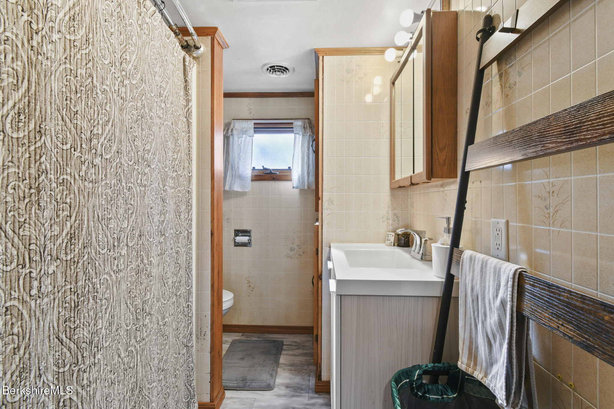 27 Shore Road Becket, MA 01223 - Photo 18 of 27 a bathroom with a sink a toilet and shower