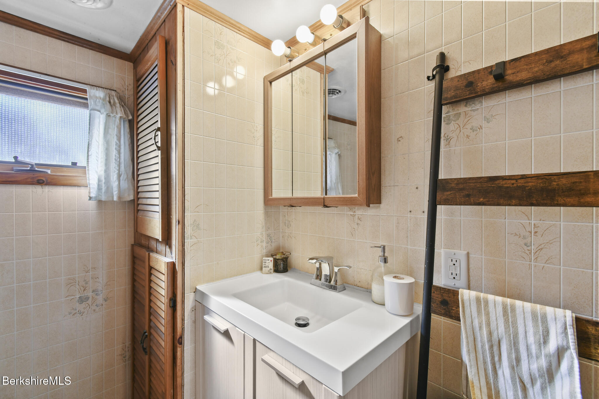 27 Shore Road Becket, MA 01223 - Photo 19 of 27 a bathroom with a sink and a mirror