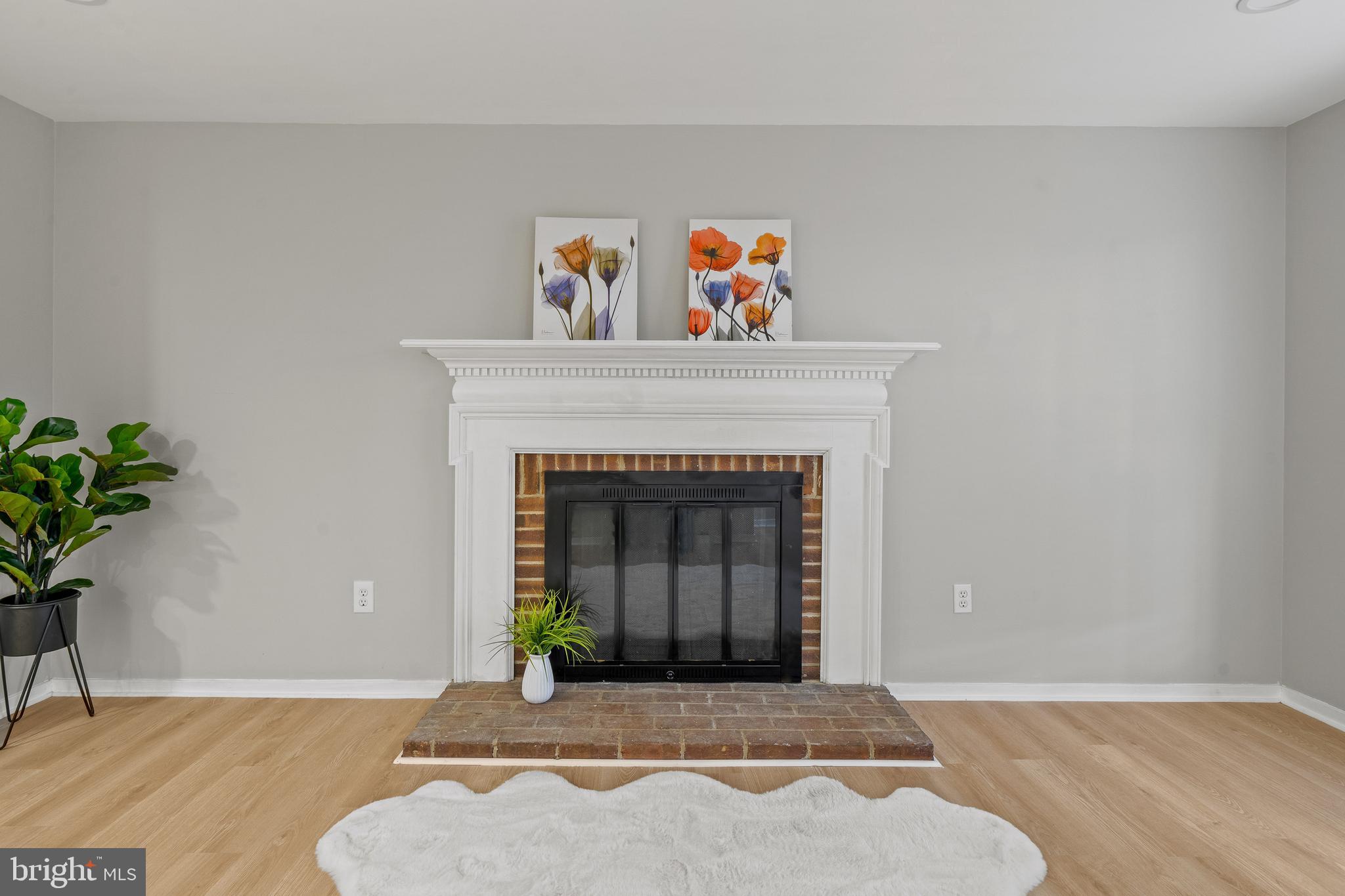 6122 Mantle Road Burke, VA 22015 - Photo 12 of 51 a living room with a fireplace and potted plant