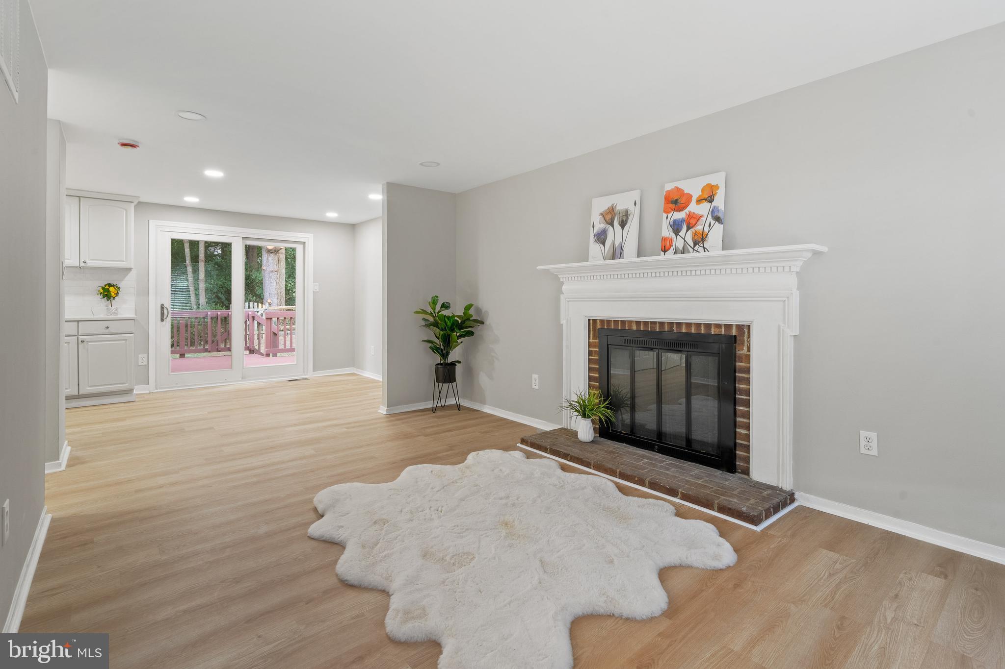 6122 Mantle Road Burke, VA 22015 - Photo 13 of 51 a view of an empty room with wooden floor and a fireplace