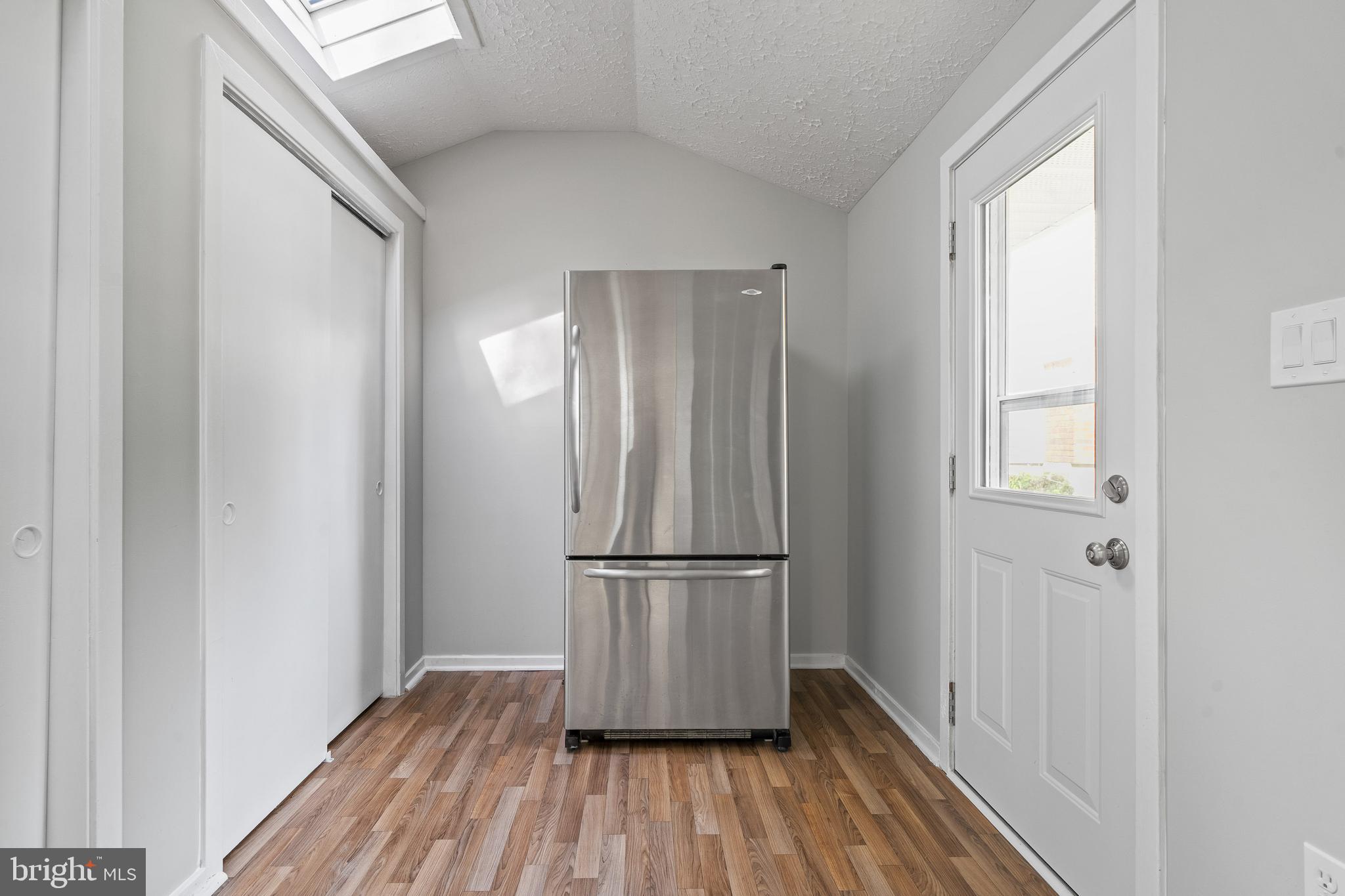 6122 Mantle Road Burke, VA 22015 - Photo 15 of 51 a view of empty room with wooden floor and entryway