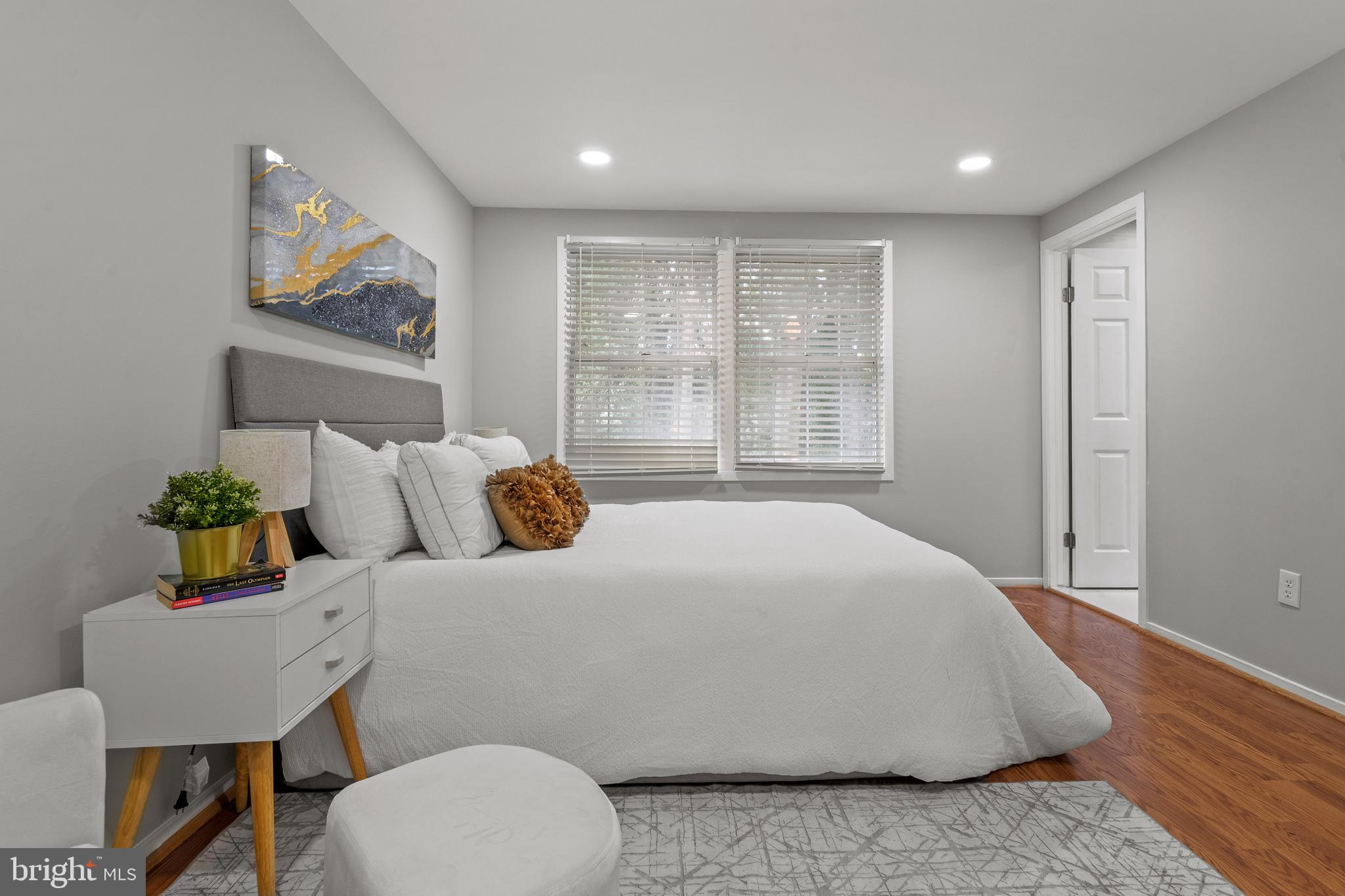 6122 Mantle Road Burke, VA 22015 - Photo 20 of 51 a bedroom with a bed a dresser and a painting on the wall
