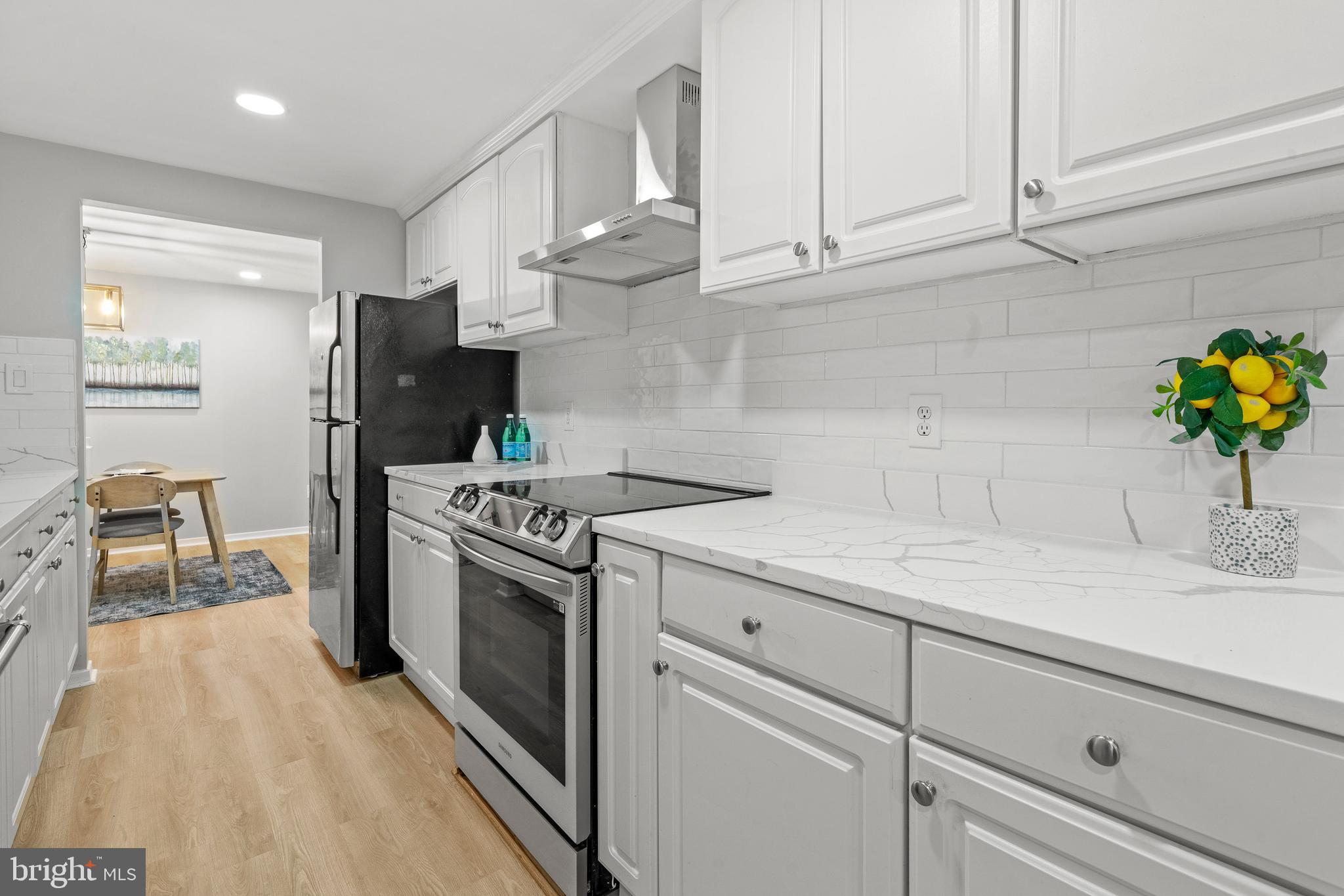 6122 Mantle Road Burke, VA 22015 - Photo 2 of 51 a kitchen with stainless steel appliances granite countertop a sink a stove and a refrigerator