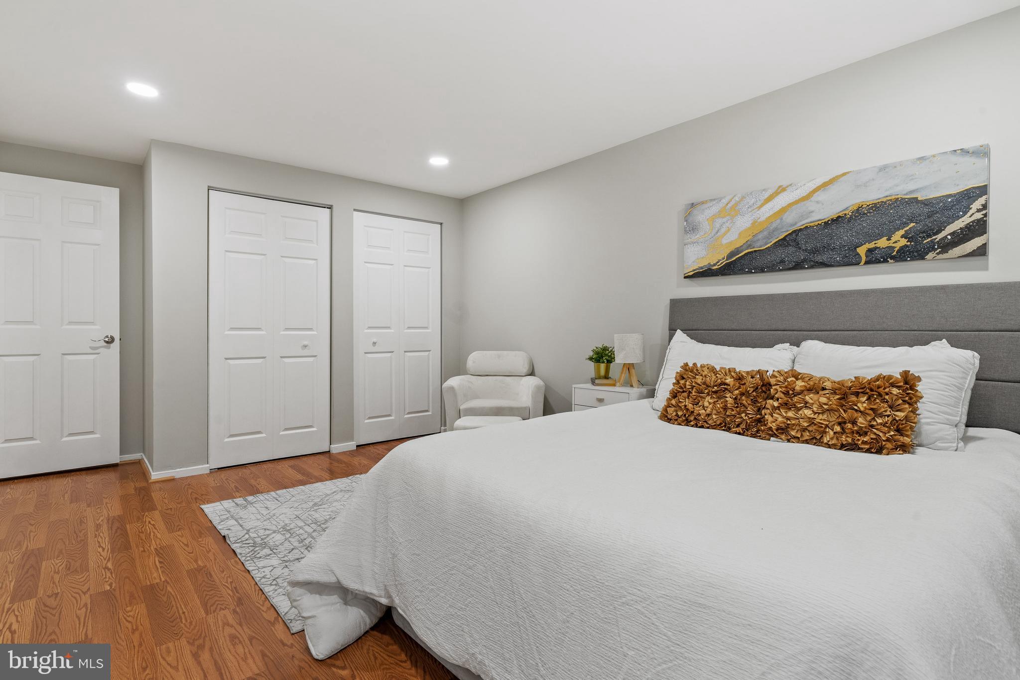 6122 Mantle Road Burke, VA 22015 - Photo 21 of 51 a bedroom with a bed and wooden floor