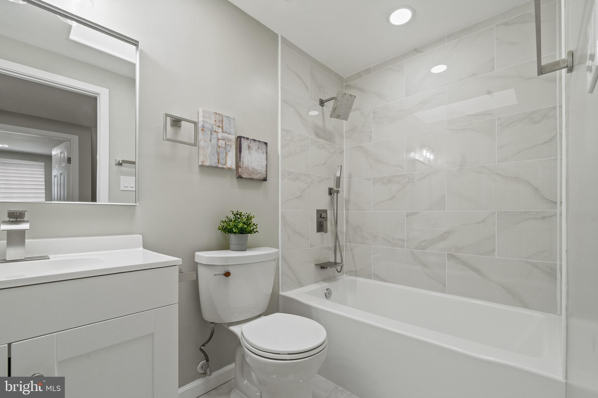 6122 Mantle Road Burke, VA 22015 - Photo 24 of 51 a bathroom with a granite countertop toilet a sink and a bathtub