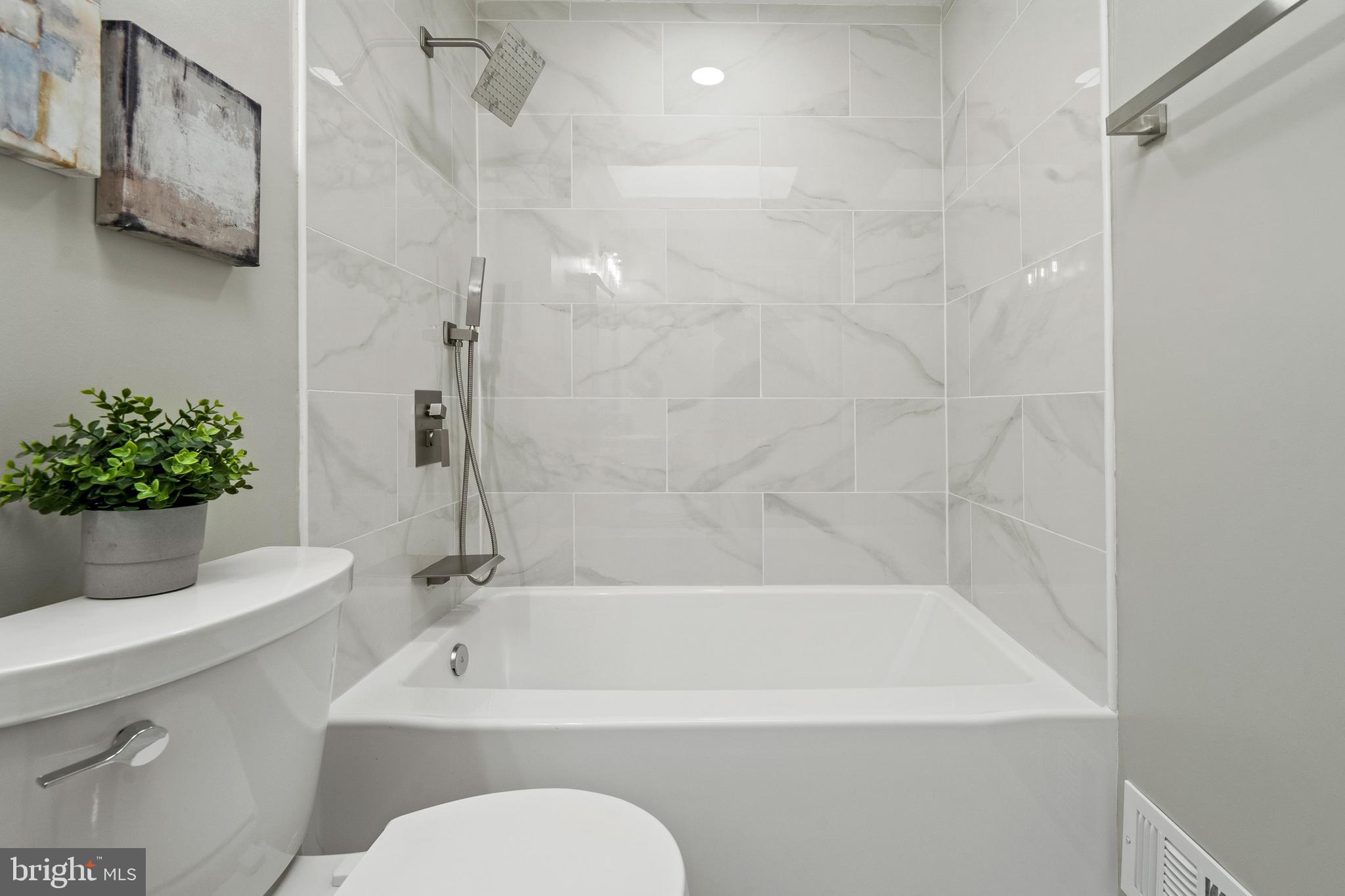 6122 Mantle Road Burke, VA 22015 - Photo 25 of 51 a white bath tub sitting next to a white toilet