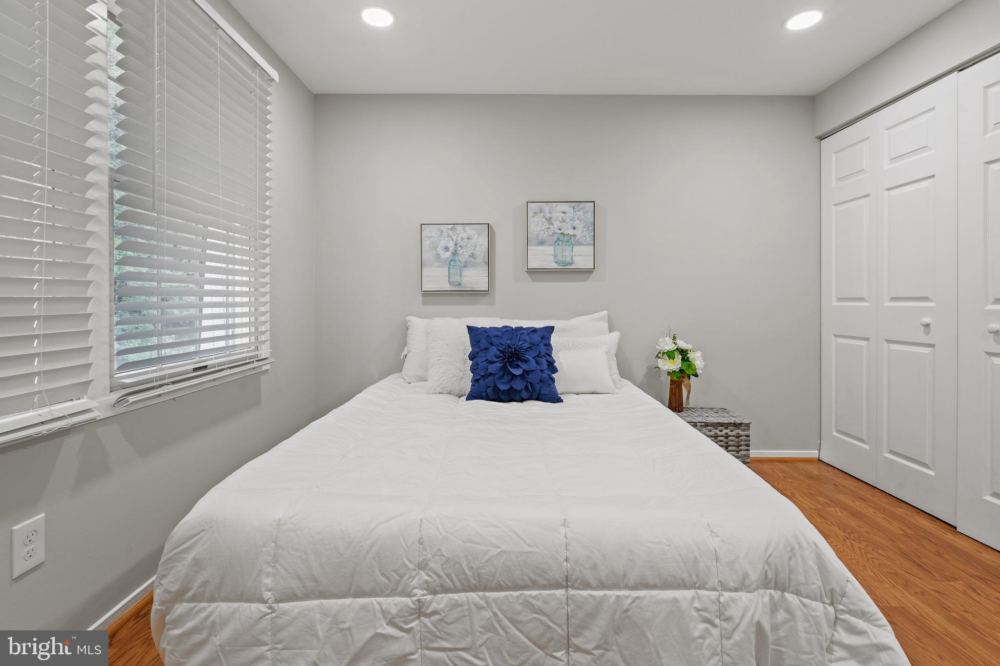 6122 Mantle Road Burke, VA 22015 - Photo 28 of 51 a bedroom with a bed and wooden floor