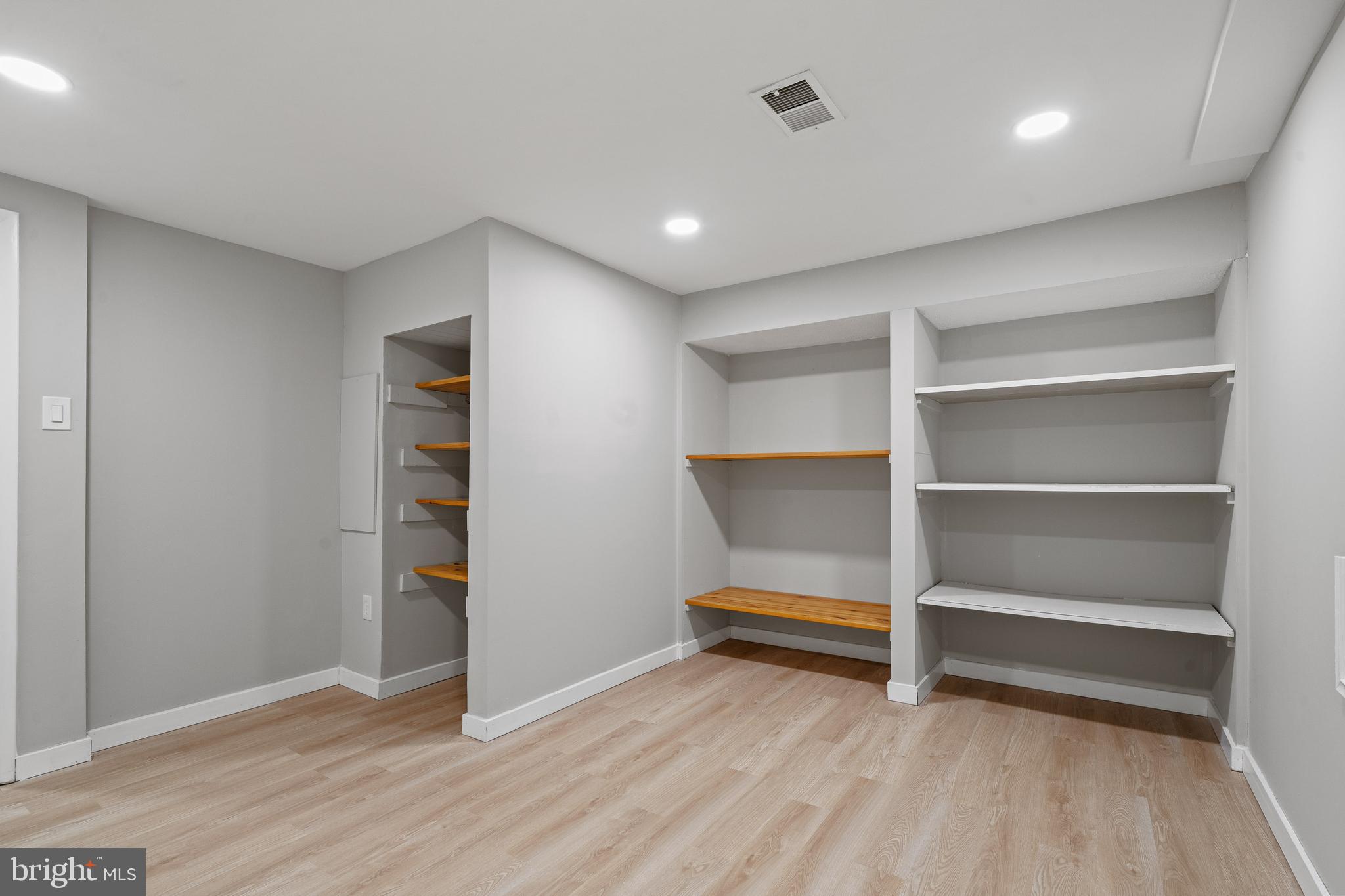 6122 Mantle Road Burke, VA 22015 - Photo 37 of 51 a view of room with walk in closet and wooden floor