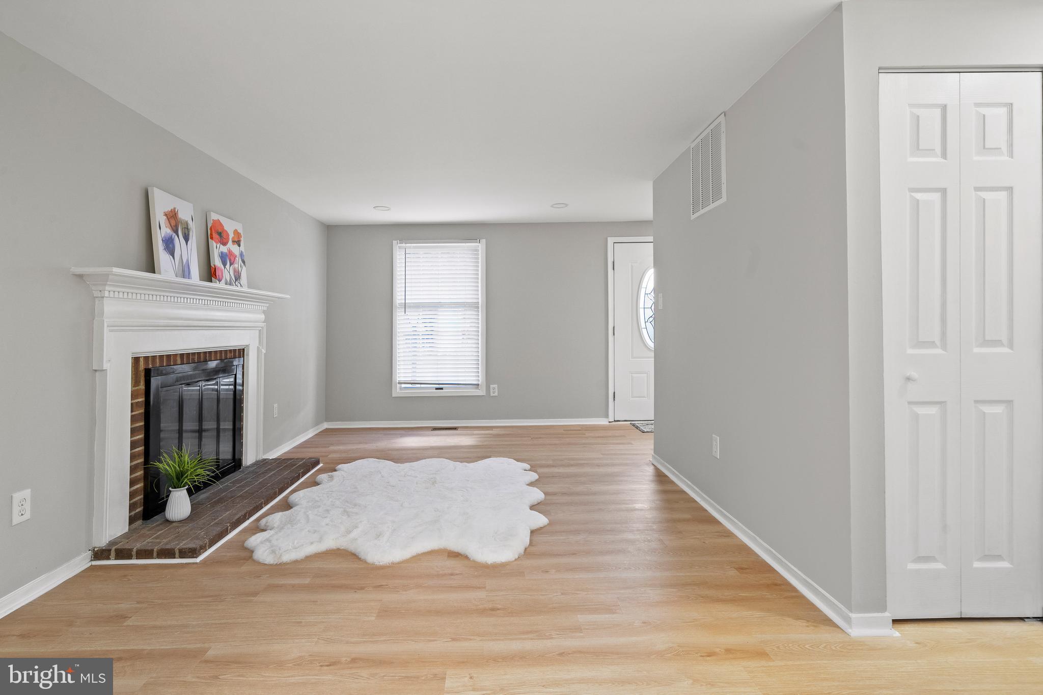 6122 Mantle Road Burke, VA 22015 - Photo 4 of 51 a view of an empty room with wooden floor and a window