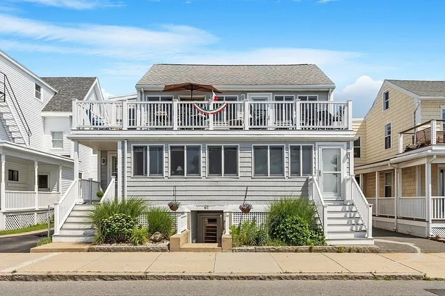 a front view of a building with a garden